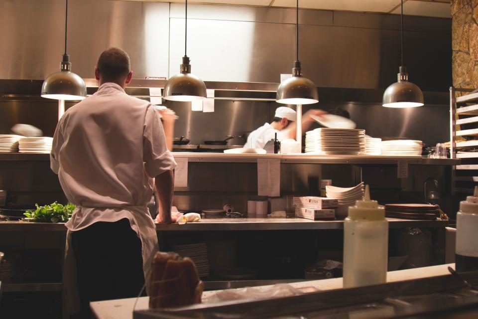 A chef working the pass in a restaurant kitchen