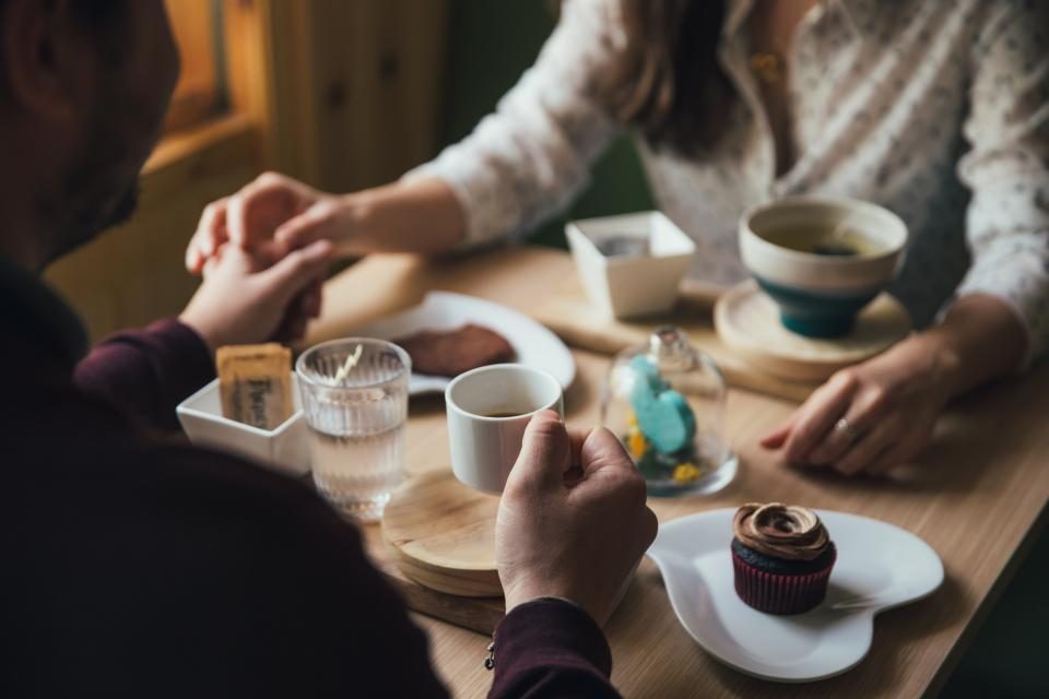 Friends sharing coffee and cake around a table