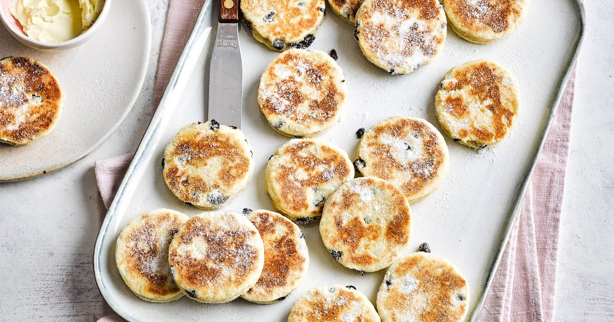 Welsh cakes cooling on a rack, dusted with sugar